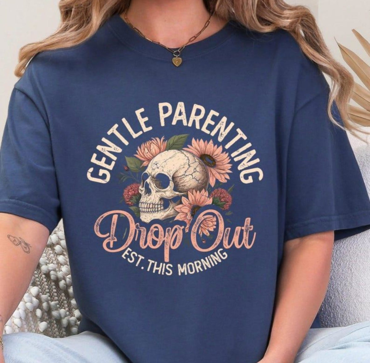 Navy blue T-shirt mockup with cream and blush Gentle Parenting Drop Out floral skull graphic