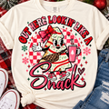 Cream T-shirt mockup with a playful Christmas tree cake character and Out Here Lookin' Like a Snack holiday design
